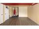 Spacious finished basement with a red accent ceiling, wood flooring, and potential rec space at 21742 E Lehigh Pl, Aurora, CO 80018