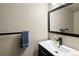 Modern bathroom vanity with sleek black fixtures, an above counter sink, and a decorative blue towel at 21742 E Lehigh Pl, Aurora, CO 80018