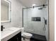 Modern bathroom featuring updated vanity, fixtures, and a glass shower with black trim at 21742 E Lehigh Pl, Aurora, CO 80018