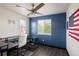 This bedroom has wood floors, white and blue walls, and a ceiling fan at 21742 E Lehigh Pl, Aurora, CO 80018