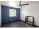 This blue bedroom has a window and a ceiling fan, plus an empty space with a mirror at 21742 E Lehigh Pl, Aurora, CO 80018