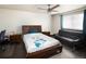 Comfortable bedroom with dark floors, a ceiling fan, and a window for natural light at 21742 E Lehigh Pl, Aurora, CO 80018