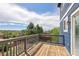 This wood deck with grey railings offers a private outdoor space with scenic neighborhood views at 21742 E Lehigh Pl, Aurora, CO 80018