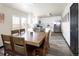 Open-concept dining area featuring a large table, laminate flooring, and access to the kitchen at 21742 E Lehigh Pl, Aurora, CO 80018