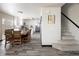 Open-concept dining and kitchen area with seating for six and easy access to a carpeted staircase at 21742 E Lehigh Pl, Aurora, CO 80018
