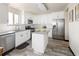 Bright kitchen featuring stainless steel appliances, granite countertops and white cabinetry, with a central island at 21742 E Lehigh Pl, Aurora, CO 80018