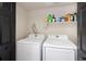 Convenient laundry room featuring modern Samsung appliances and a storage shelf above at 21742 E Lehigh Pl, Aurora, CO 80018