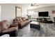 Cozy living room featuring comfortable seating, fan, window and wood-style laminate flooring at 21742 E Lehigh Pl, Aurora, CO 80018