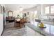 Open-concept living room and kitchen with modern finishes and hardwood floors throughout at 21742 E Lehigh Pl, Aurora, CO 80018