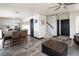 Spacious living room featuring comfortable seating, ceiling fan, laminate floors, dining area and foyer at 21742 E Lehigh Pl, Aurora, CO 80018