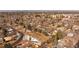 Aerial view of vacant lot surrounded by mature trees and neighborhood homes at 434 S Newport Way, Denver, CO 80224