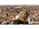 The aerial view shows the vacant lot in a neighborhood and the skyline in the distance at 434 S Newport Way, Denver, CO 80224