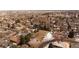 An aerial view shows the vacant lot nestled in a neighborhood with mature trees and the city in the distance at 434 S Newport Way, Denver, CO 80224