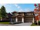 Two-story home with stone and wood exterior, attached garage, and landscaping at 1020 24Th St, Golden, CO 80401