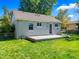Home exterior with a concrete patio, small windows, and lush green grass at 1941 S Dexter St, Denver, CO 80222