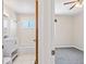 Bathroom view featuring a toilet, vanity sink, tiled shower/tub, and doorway to bedroom at 1941 S Dexter St, Denver, CO 80222