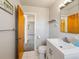 The bathroom has a modern vanity and easy access to the carpeted bedroom through a wood door at 1941 S Dexter St, Denver, CO 80222