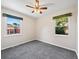Bright bedroom features neutral walls, gray carpeting, two windows, and a ceiling fan with lighting at 1941 S Dexter St, Denver, CO 80222