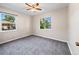 This bedroom features neutral walls, gray carpeting, two windows, and ceiling fan with lighting at 1941 S Dexter St, Denver, CO 80222