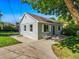 Charming single-story home featuring a well-maintained lawn and inviting front entrance with bench at 1941 S Dexter St, Denver, CO 80222