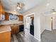 Kitchen with wood cabinets, black appliances, and gray vinyl floors at 1941 S Dexter St, Denver, CO 80222