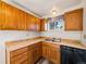Kitchen featuring wood cabinets, laminate countertops, and vinyl flooring at 1941 S Dexter St, Denver, CO 80222
