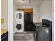 Stacked laundry machines next to black refrigerator at 1941 S Dexter St, Denver, CO 80222