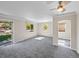 Bright and spacious living room featuring neutral walls, soft carpet, ceiling fan and ample natural light at 1941 S Dexter St, Denver, CO 80222