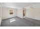Living room with neutral tones, carpet, and a dining area at 1941 S Dexter St, Denver, CO 80222
