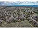 Expansive aerial view of a suburban community surrounded by green spaces, illustrating neighborhood layout at 1563 Baguette Dr, Castle Rock, CO 80108