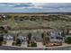 Aerial view showcases a residential neighborhood surrounded by natural open spaces and green hills at 1563 Baguette Dr, Castle Rock, CO 80108
