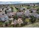 Aerial view of a home with a patio, fire pit, and well-manicured backyard in a suburban community at 1563 Baguette Dr, Castle Rock, CO 80108
