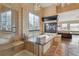 Luxurious primary bathroom featuring a glass shower, soaking tub, and a cozy fireplace at 1563 Baguette Dr, Castle Rock, CO 80108