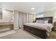 Spacious bedroom features a large bed, neutral tones and an attached vanity/sink area at 1563 Baguette Dr, Castle Rock, CO 80108