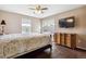 Bright bedroom with large windows, a comfortable bed, and an elegant dresser at 1563 Baguette Dr, Castle Rock, CO 80108