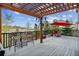 Outdoor deck area with pergola, seating, and views of the surrounding landscape at 1563 Baguette Dr, Castle Rock, CO 80108