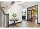 Inviting entryway featuring hardwood floors, an elegant staircase, and a decorative table with fresh flowers at 1563 Baguette Dr, Castle Rock, CO 80108