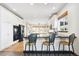 Bright, modern kitchen with white cabinets, a dark island, and stainless steel appliances at 1563 Baguette Dr, Castle Rock, CO 80108