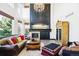 Elegant living room with high ceilings, large windows, a fireplace, and stylish decor at 1563 Baguette Dr, Castle Rock, CO 80108