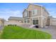 The fenced backyard features a well-kept lawn, a patio, and low-maintenance gravel at 4408 Riviera Ct, Aurora, CO 80019