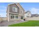This backyard features a well-kept lawn, a small patio with a grill, and low-maintenance gravel at 4408 Riviera Ct, Aurora, CO 80019