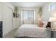 Bedroom features a large window, leafy decor and a white comforter at 4408 Riviera Ct, Aurora, CO 80019
