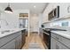 Modern kitchen featuring stainless steel appliances, gray cabinets, and plenty of counter space at 4408 Riviera Ct, Aurora, CO 80019