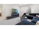 Living room boasts a comfortable couch, entertainment center, and plush carpeting at 4408 Riviera Ct, Aurora, CO 80019