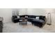 Living room boasts a comfortable sectional couch, stylish coffee table, and plush carpeting at 4408 Riviera Ct, Aurora, CO 80019