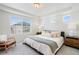 Bright main bedroom features a large window, neutral bedding, tray ceiling, and carpeted floor at 4408 Riviera Ct, Aurora, CO 80019