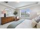 Bright main bedroom with a large mirror, dresser, and a green throw on the bed at 4408 Riviera Ct, Aurora, CO 80019