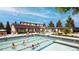 Community pool with leisure bathers with modern architecture, perfect for relaxation and recreation at 4408 Riviera Ct, Aurora, CO 80019