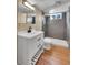 Modern basement bathroom with gray tile shower and white vanity at 7505 Clay St, Westminster, CO 80030