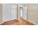 Simple bedroom with hardwood floors and access to hallway at 7505 Clay St, Westminster, CO 80030